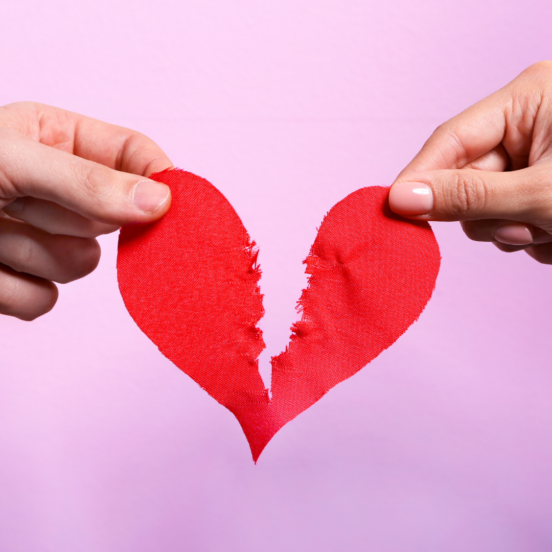 red paper heart ripped in half